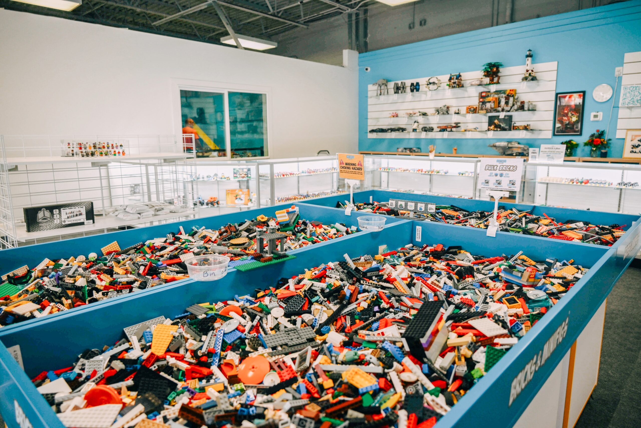Bricks and Minifigs® Store Filled With Bulk Brick Tables and Sets on Walls