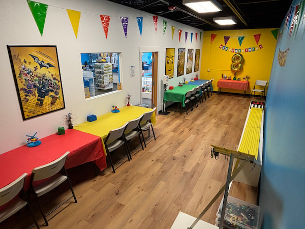 hands-holding-minifigs-event-745x371-1-500x249-1 Bricks & Minifigs birthday party room inside the toy store