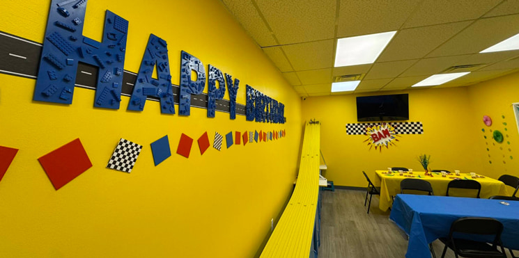 interior of birthday party room at toy store showing decor and tablesqq