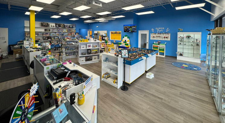 interior of Bricks and Minifigs toy store showing lots of LEGO® stuff on display