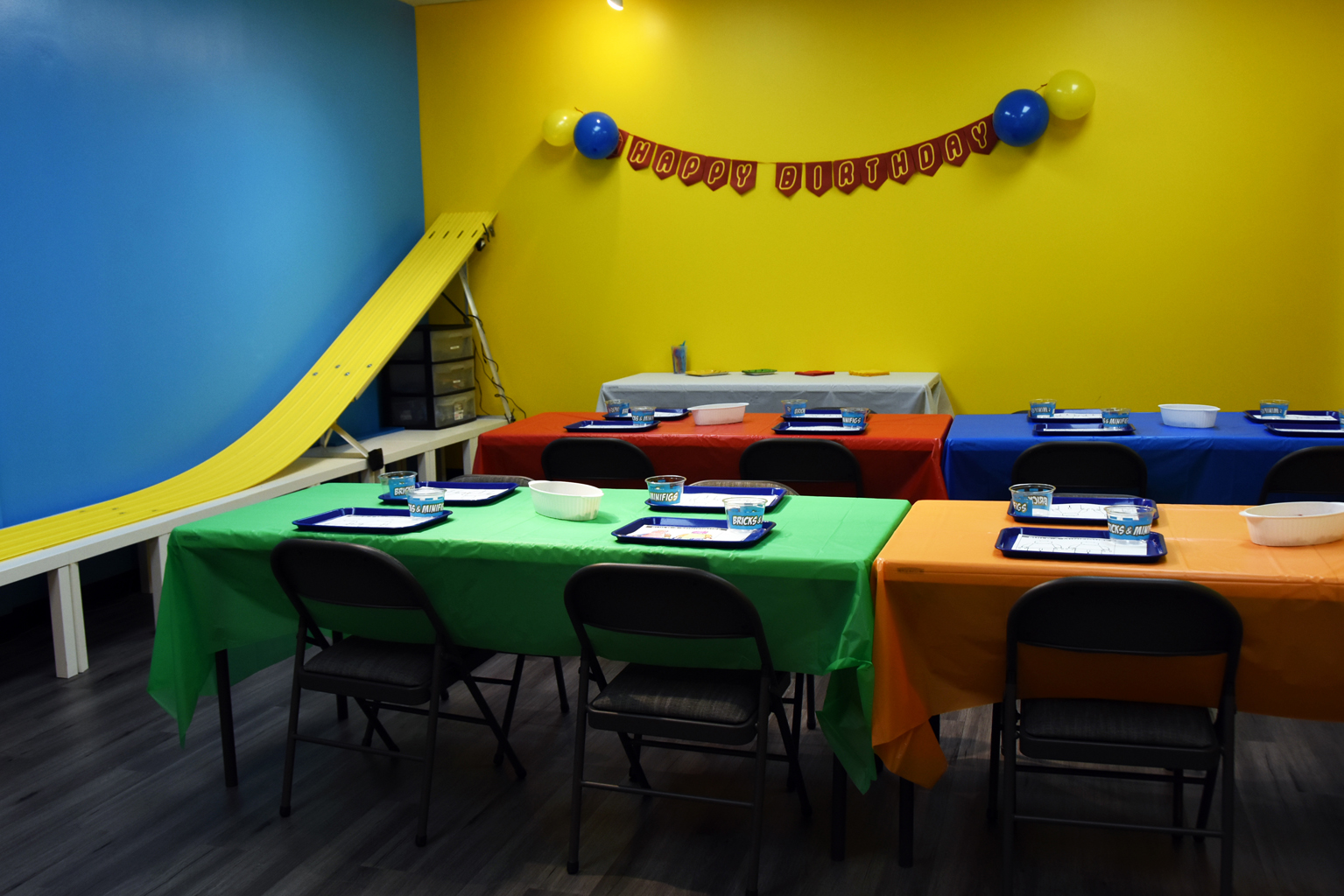 LEGO birthday party room with happy birthday banner at Bricks & Minifigs Schaumburg for kids parties and events
