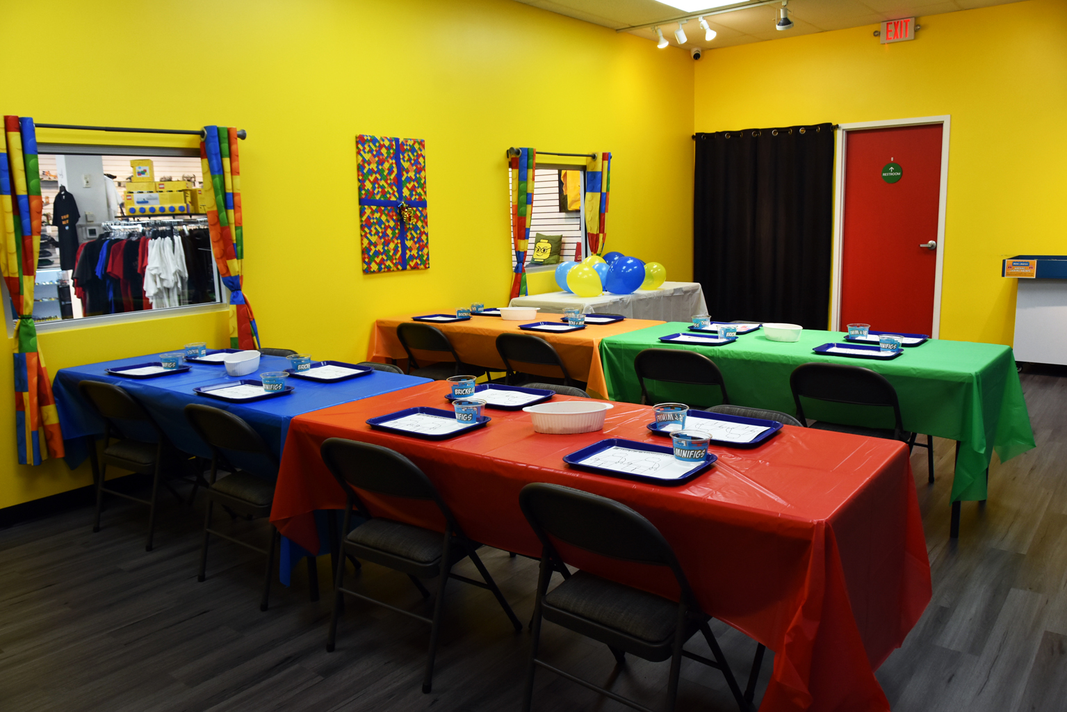 LEGO® party room with colorful building tables and kids activity stations at Bricks & Minifigs Schaumburg