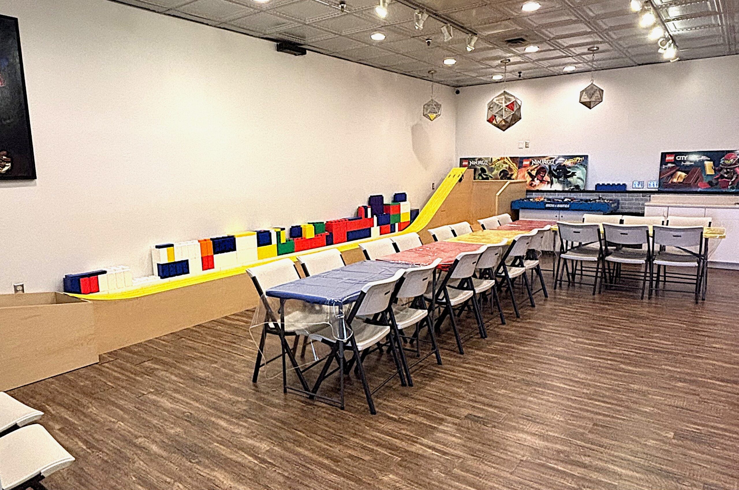 birthday party room showing tables, decor, and derby race track