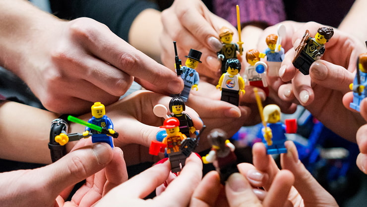 close up several people holding mini figurines