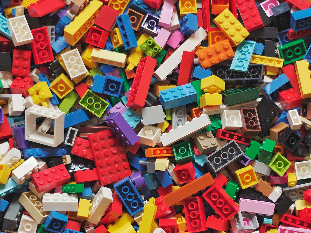 A table filled with LEGO® of all colors, shapes, and sizes.
