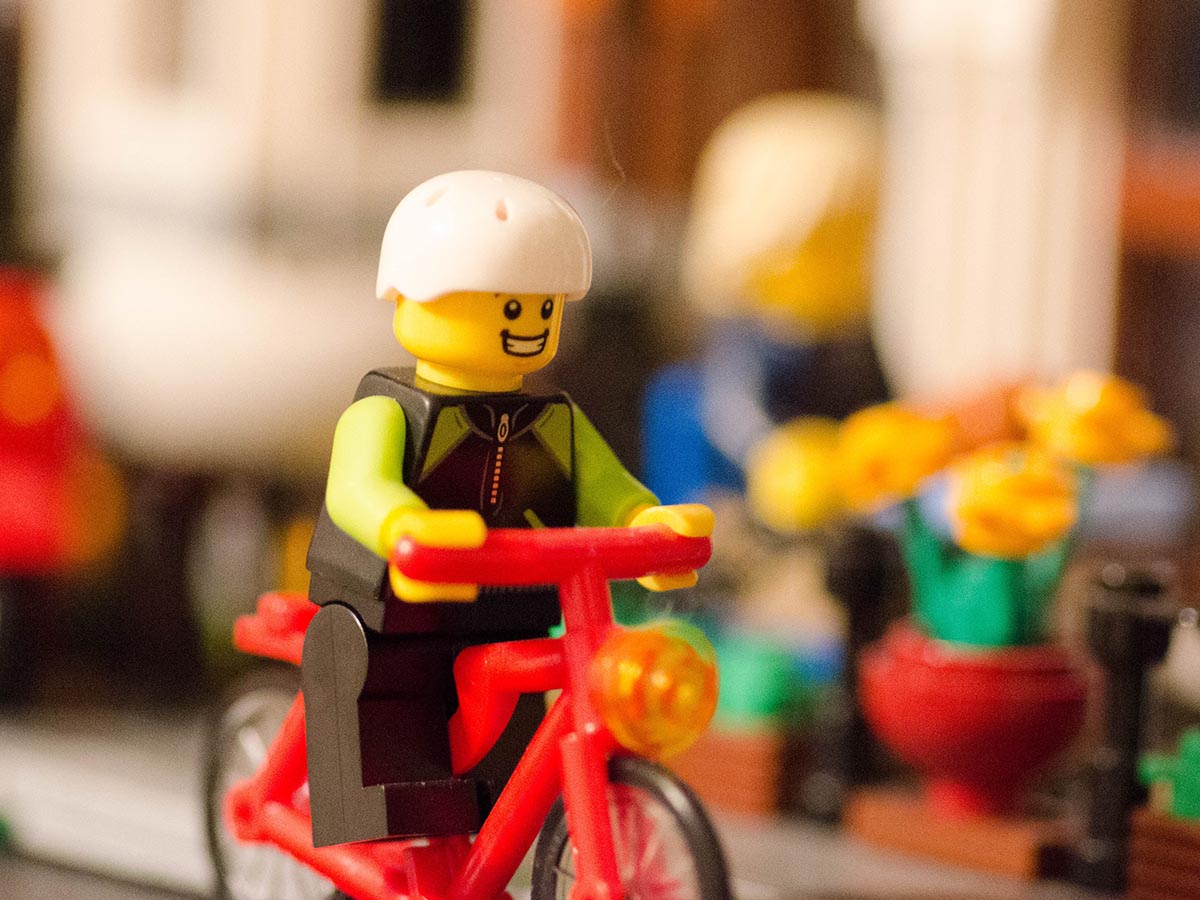 LEGO minifigure riding a motorcycle.