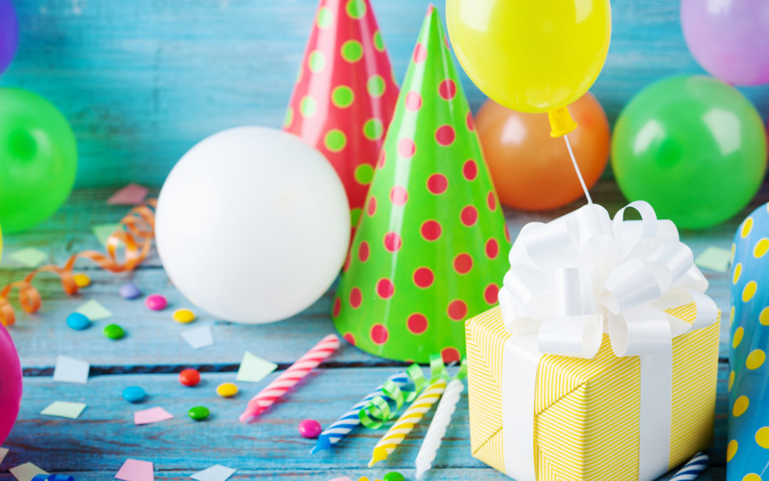 Party hat and balloons on table