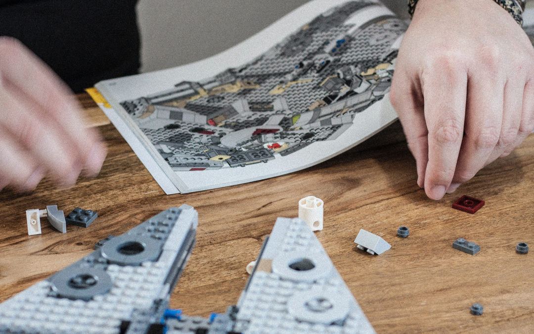 Man building LEGO millennium falcon