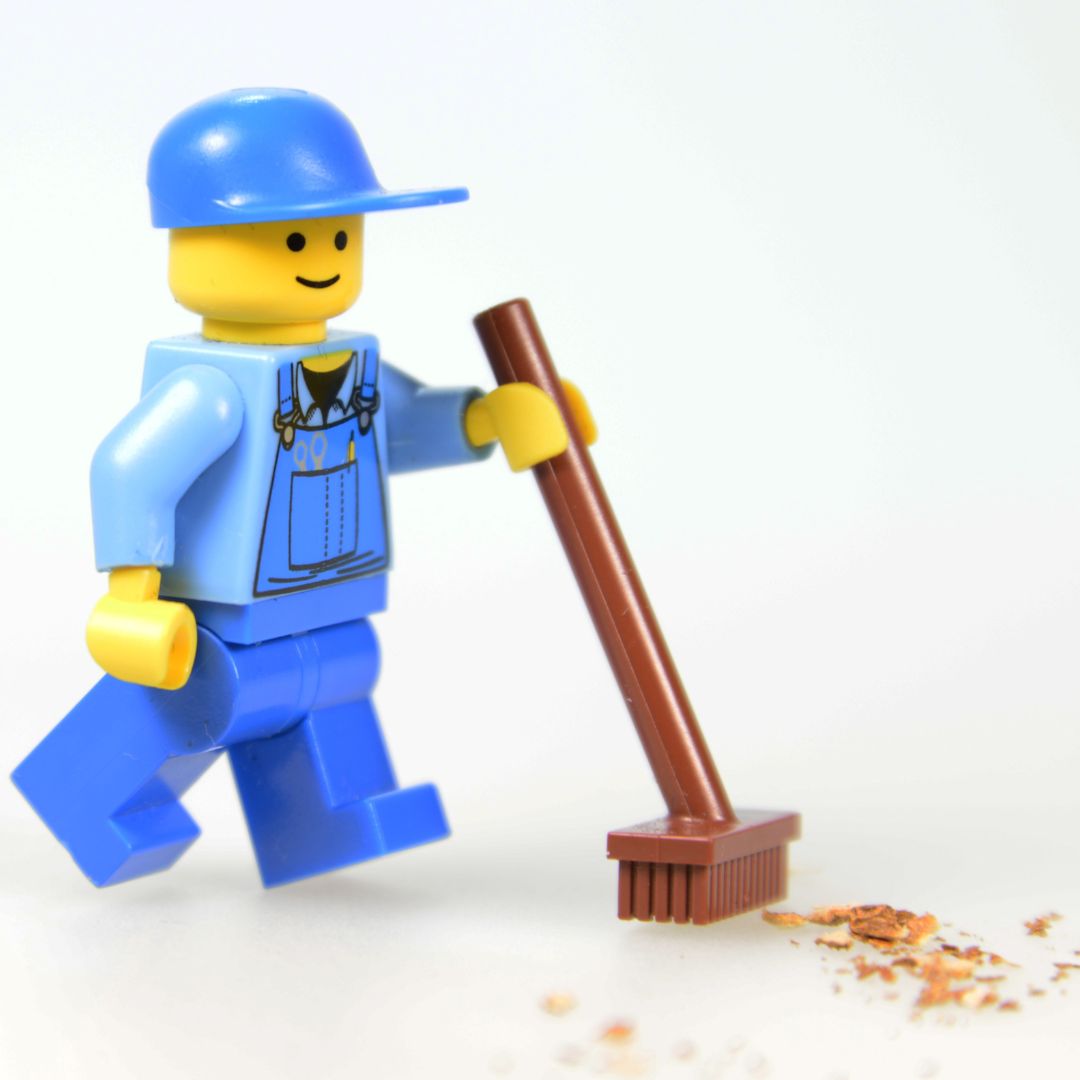 Janitor Lego figurine with broom