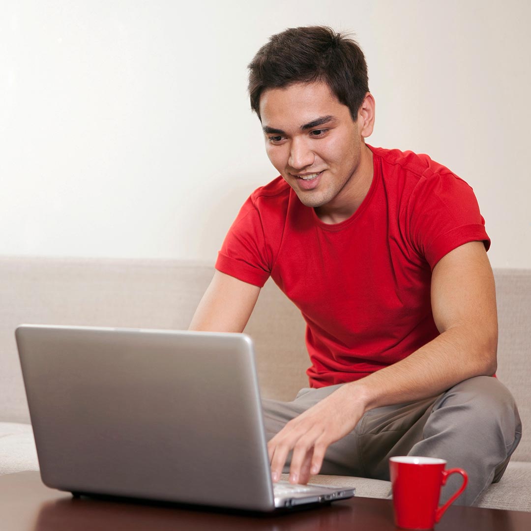 Happy man using a laptop