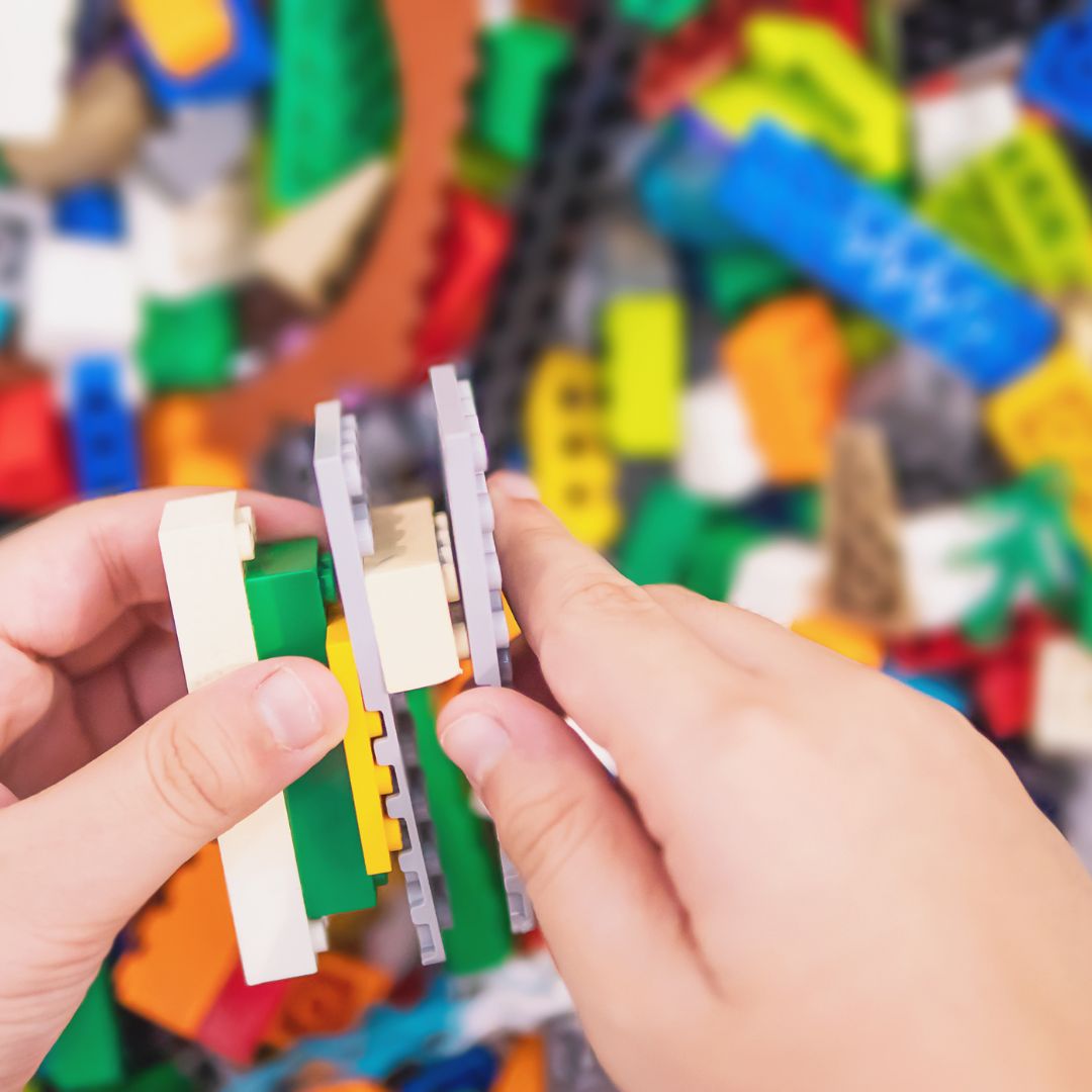 person playing with LEGO