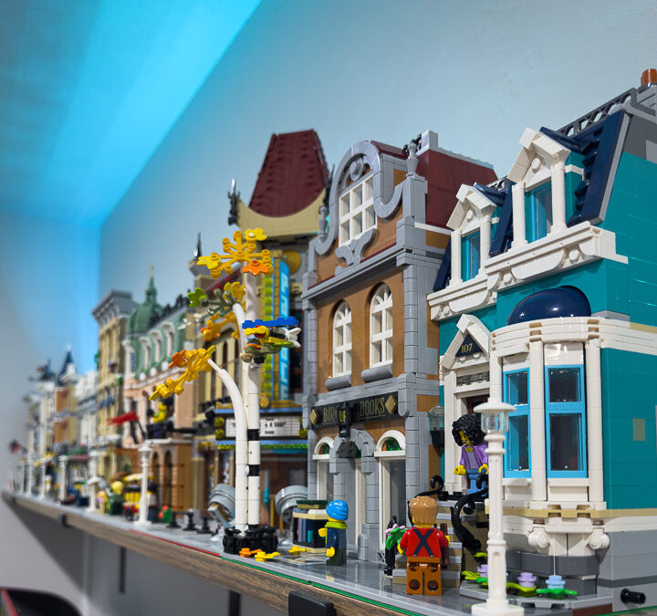 A wall shelf filled with LEGO® buildings.