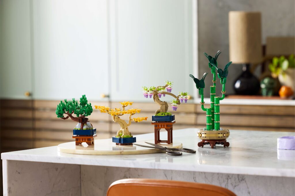A LEGO Bamboo set and Mini Bonsai Tree sets on a marble counter