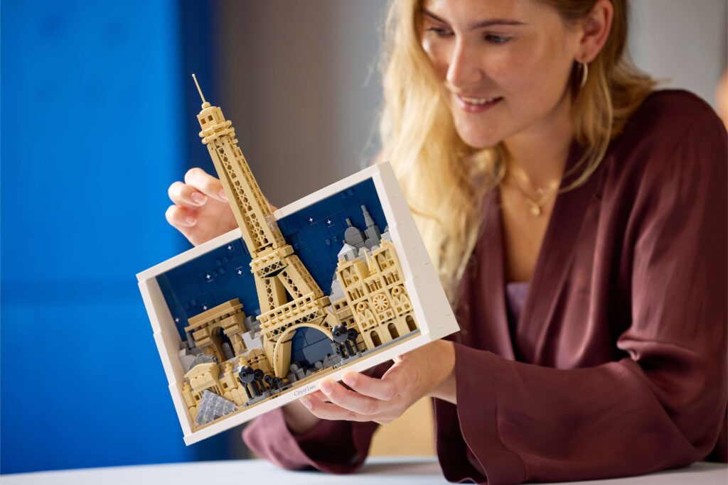 A woman holding the Paris – City of Love LEGO® set.