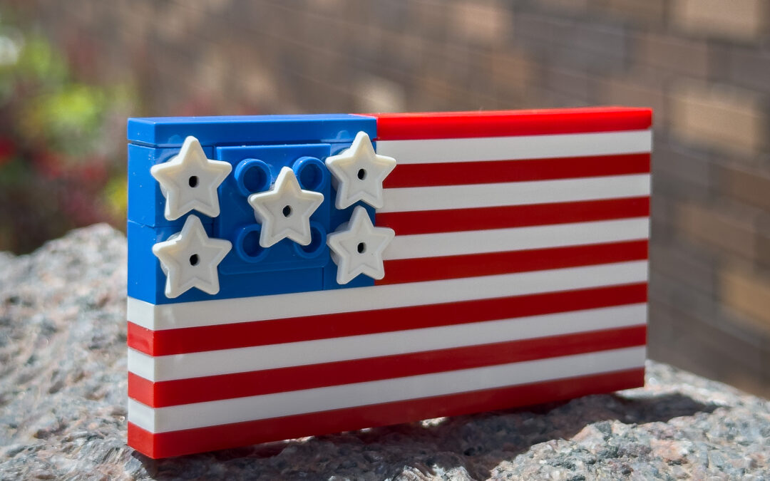 An American flag built out of LEGO® bricks on a rock.